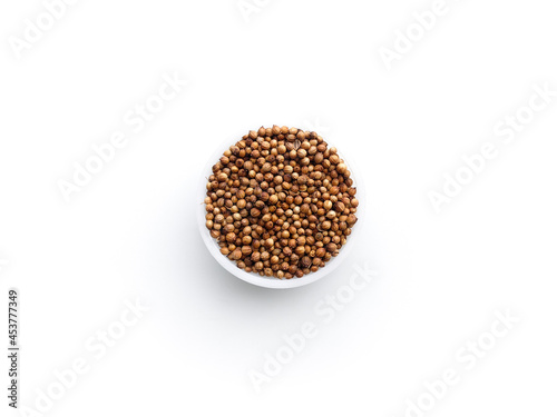 Coriander fruit isolate.  A sample of coriander seeds on a white background.  A sample of coriander seeds in a round bowl.
