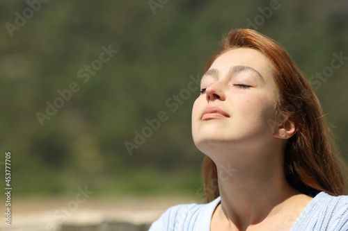 Woman relaxing breathing fresh air a sunny day