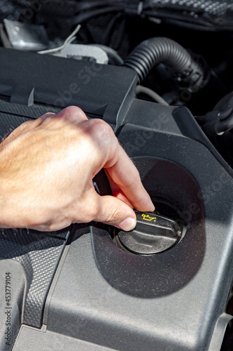 Close up shot of mechanic checking motor oil level in the car engine