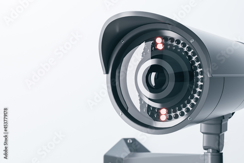 Close up of cctv camera on light background with mock up place for your text and advertisement. Control system concept. 3D Rendering.