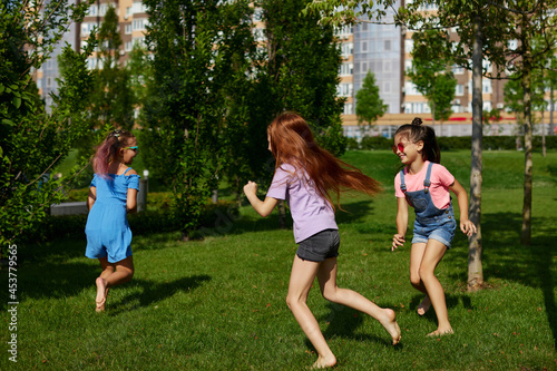 happy cute children girls run in the park