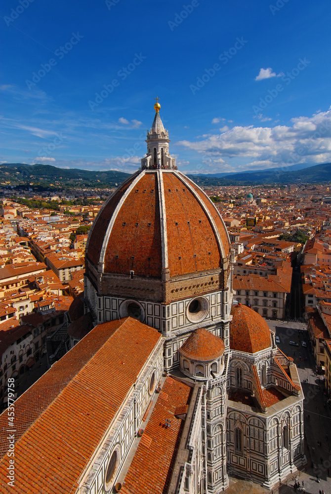 Aerial view of wonderful dome of Santa Maria del Fiore (St Mary of the Flower) with tourists at the top and the city of Florence characteristic red tiles. Built by italian architect Brunelleschi in th
