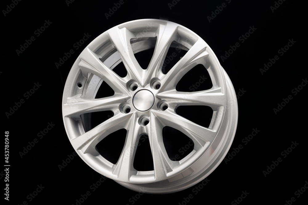 alloy wheel close-up. New modern auto parts, black background