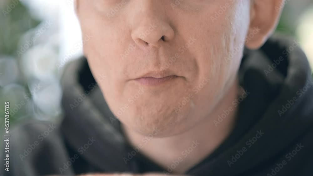 Close up Man mouth chews delicious food. Healthy and unhealthy nutrition. Close up Man mouth chews delicious food. Healthy and unhealthy nutrition.