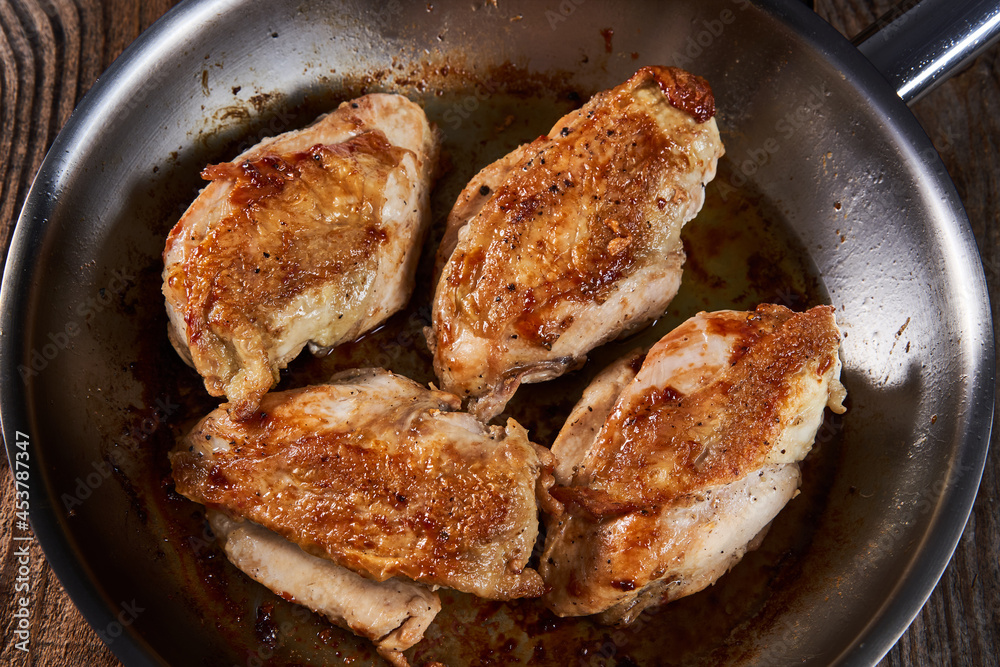 Seared chicken breasts in a pan Seared chicken breasts in a pan