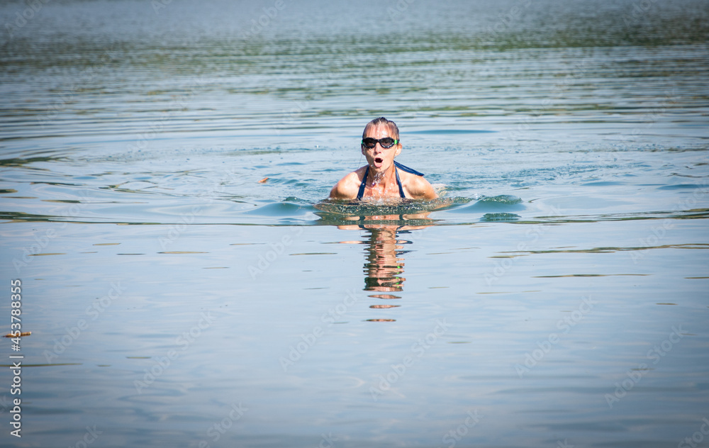 woman swimming in open water lake
