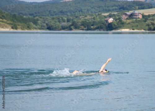 woman swimming in open water lake
