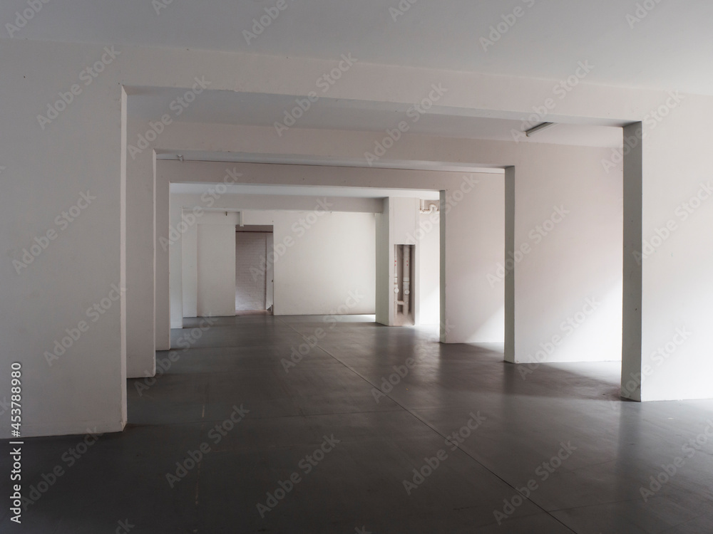 Abstract, empty void deck of an apartment block with sunlight streaming in Abstract, empty void deck of an apartment block with sunlight streaming in