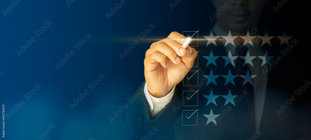 Checklist concept businessman checking mark on the checkboxes with marker white with a virtual screen, modern on dark blue background concept, can put your text at the pen, copy space