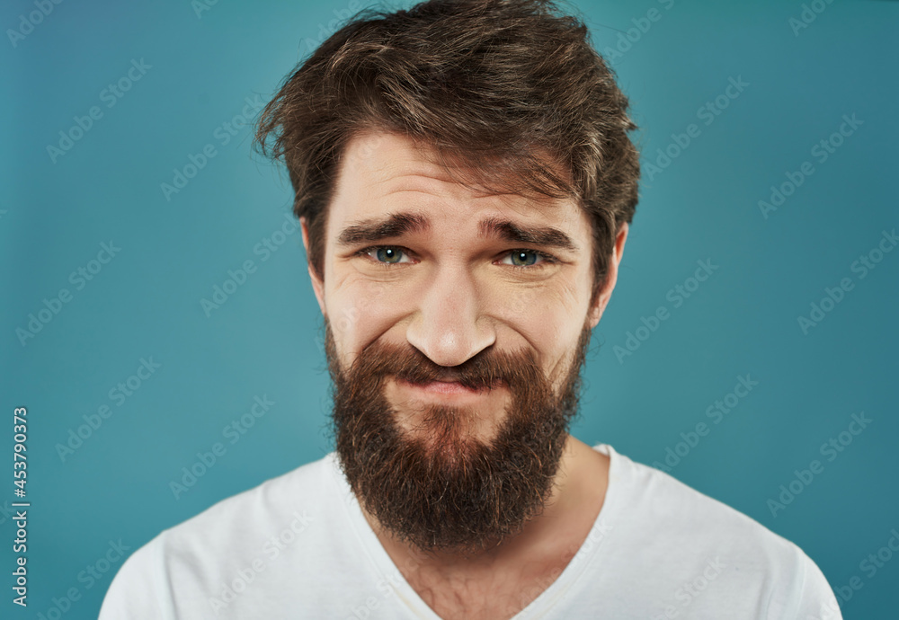 Fototapeta premium emotional man in a white t-shirt serious look Studio