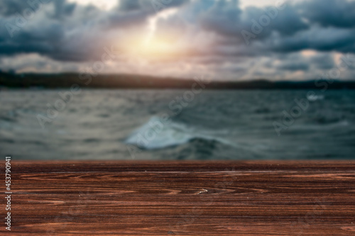 Wooden table on a dark autumn day on the seashore  © magdal3na