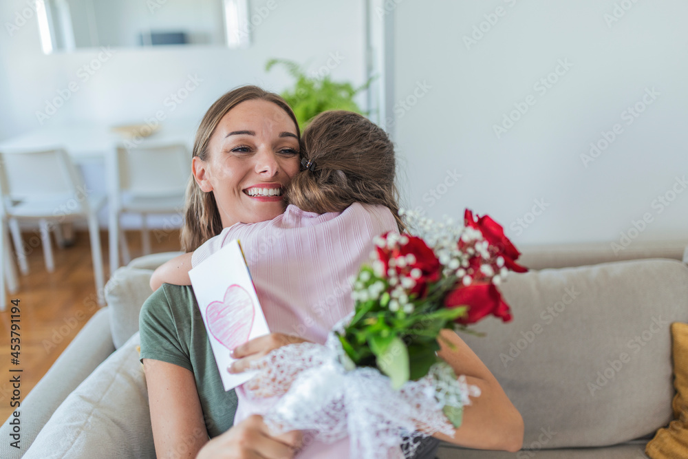 I love my you mom! Attractive young woman with little cute girl are spending time together at home, thanking for handmade card with love symbol and flowers. Happy family concept. Mother's day. I love my you mom! Attractive young woman with little cute girl are spending time together at home, thanking for handmade card with love symbol and flowers. Happy family concept. Mother's day.