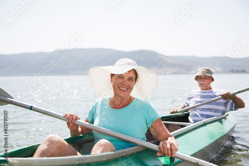 Senior couple enjoying kayaking on the river. Social Distancing. Digital detox. Staycations, hyper-local travel, family outing, getaway. Portrait of a happy senior enjoying the day on the lake.