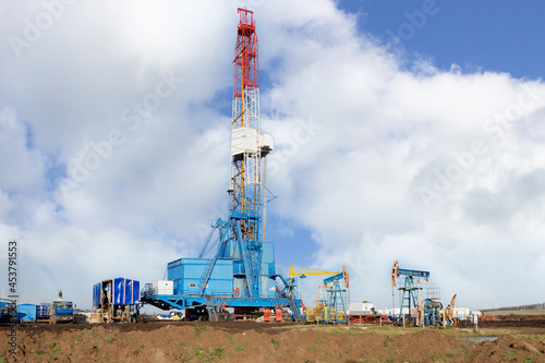 Land oil drilling rig against the blue sky 