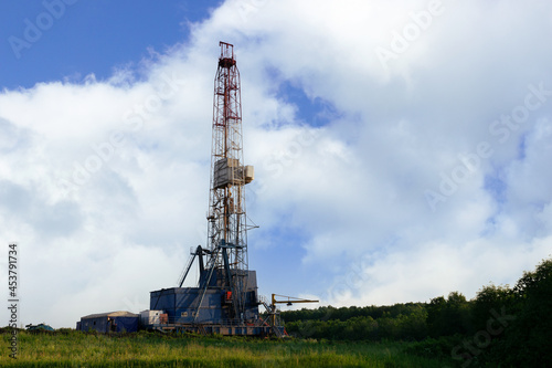 Land oil drilling rig against the blue sky 
