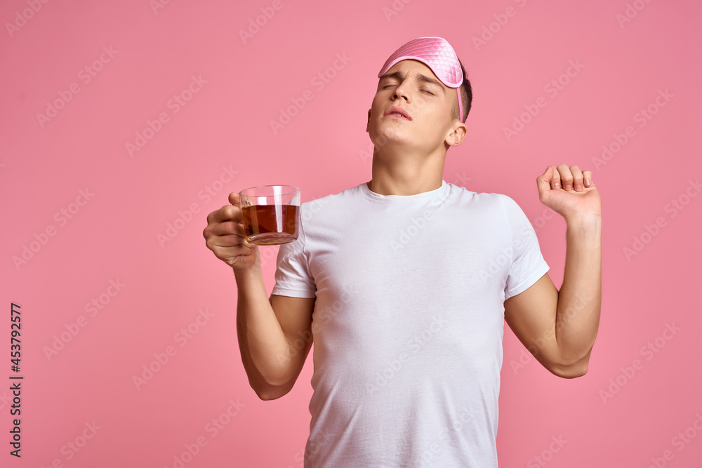 man in white t-shirt pink background relaxation at home studio man in white t-shirt pink background relaxation at home studio