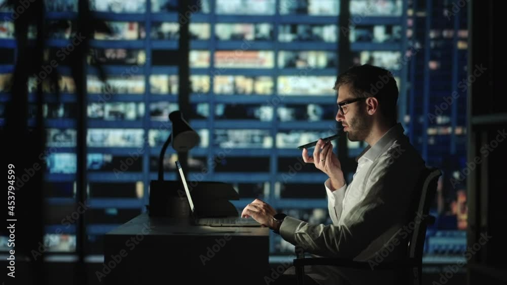 Young man recording voice recognition message on speakerphone. Businessman using virtual assistant app sets reminder on smart phone at night home office. Digital ai mobile assistance tech concept