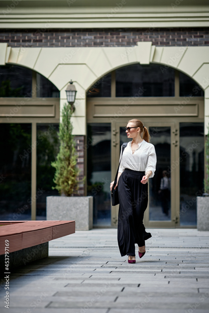 beautiful woman in sunglasses in the street beautiful woman in sunglasses in the street