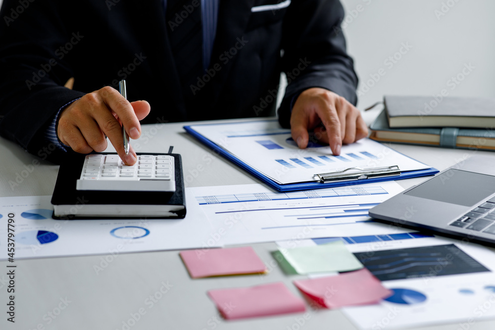 Business man working on project for analyzing company financial report balance statement with documents graphics at modern office. business,economy, market,money and tax concept . Business man working on project for analyzing company financial report balance statement with documents graphics at modern office. business,economy, market,money and tax concept .