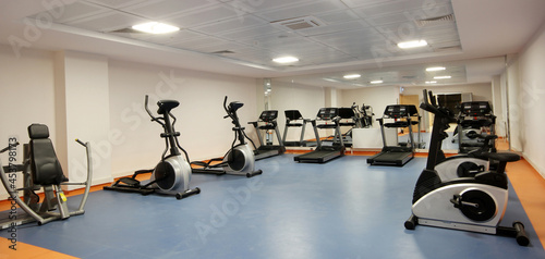 A group of exercise equipment in an empty gym