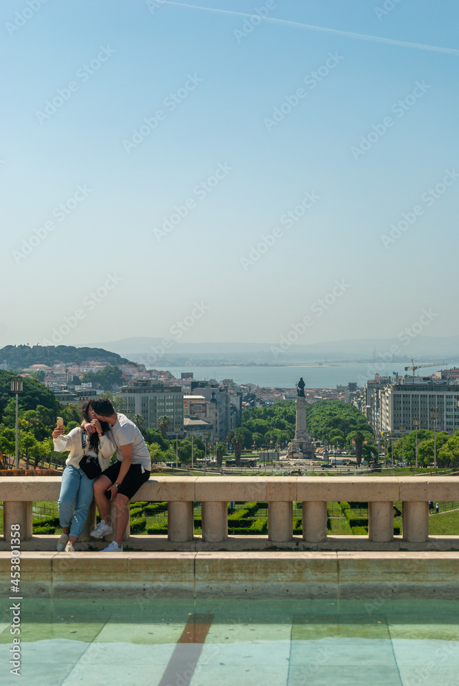 Lisbon, Portugal - May 29, 2021: A couple kissing against the background of the city of Lisbon - Portugal, Vertical, Selective focus Lisbon, Portugal - May 29, 2021: A couple kissing against the background of the city of Lisbon - Portugal, Vertical, Selective focus