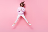 Full length body size view of nice cheerful wavy-haired girl jumping having fun asking favor gift isolated on pink pastel color background