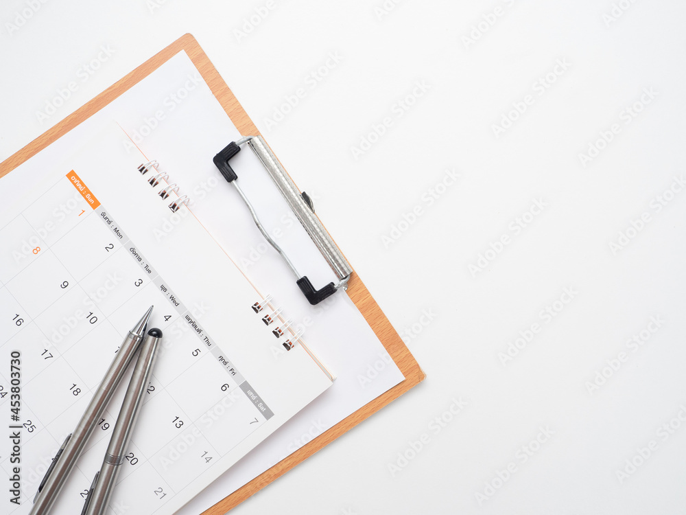 Close up pen on calendar with document board on the table top view isolated copy space Close up pen on calendar with document board on the table top view isolated copy space
