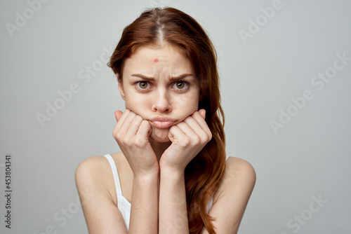 pretty woman with a pimple on the face isolated background