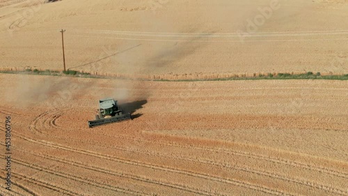 Aerial: Wheat combine harvester on wheat field, Waitsburg, Washington, USA photo