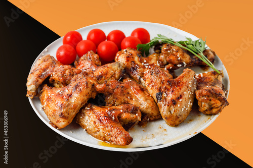 Chicken Wings On Levitation Plate On Black And Orange Background. 