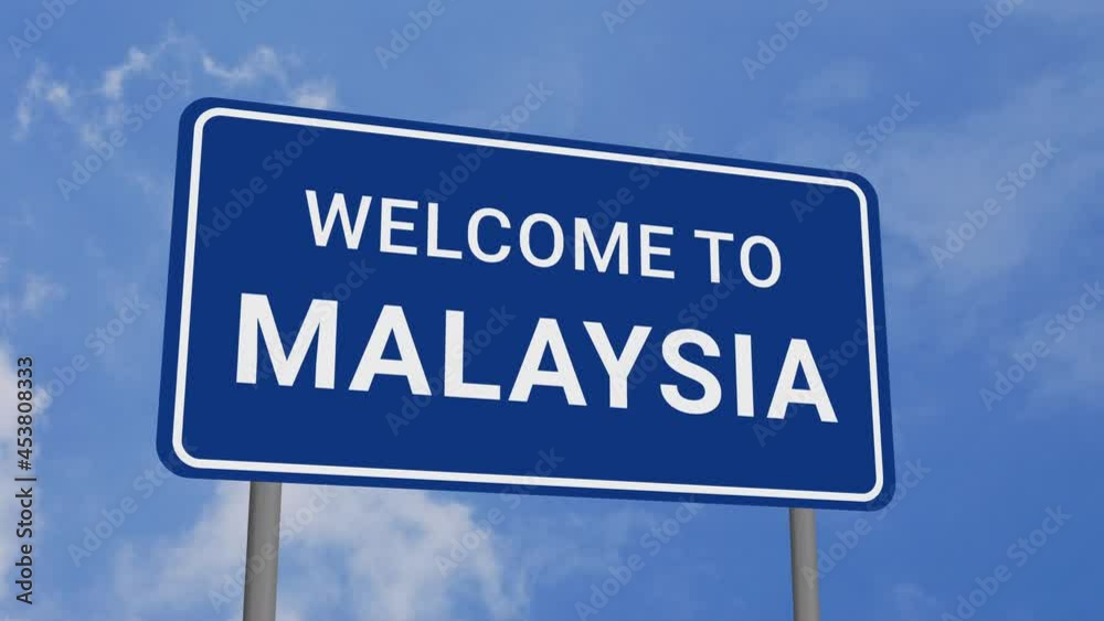 Welcome to Malaysia Road Sign on Clear Blue Sky with Rapid Moving Clouds Welcome to Malaysia Road Sign on Clear Blue Sky with Rapid Moving Clouds