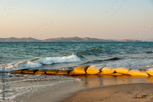 Fototapeta Naklejka Na Ścianę i Meble -  Sandbags as protection against erosion on the sandy beach of Kos