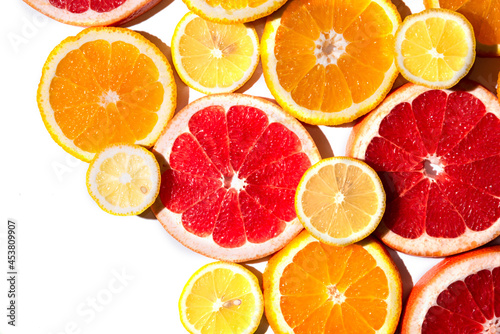 Bright multicolored citrus slices isolated on white background.