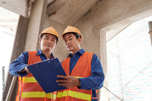 Принти на полотні General contractor checking construction progress report of subcontractor when t