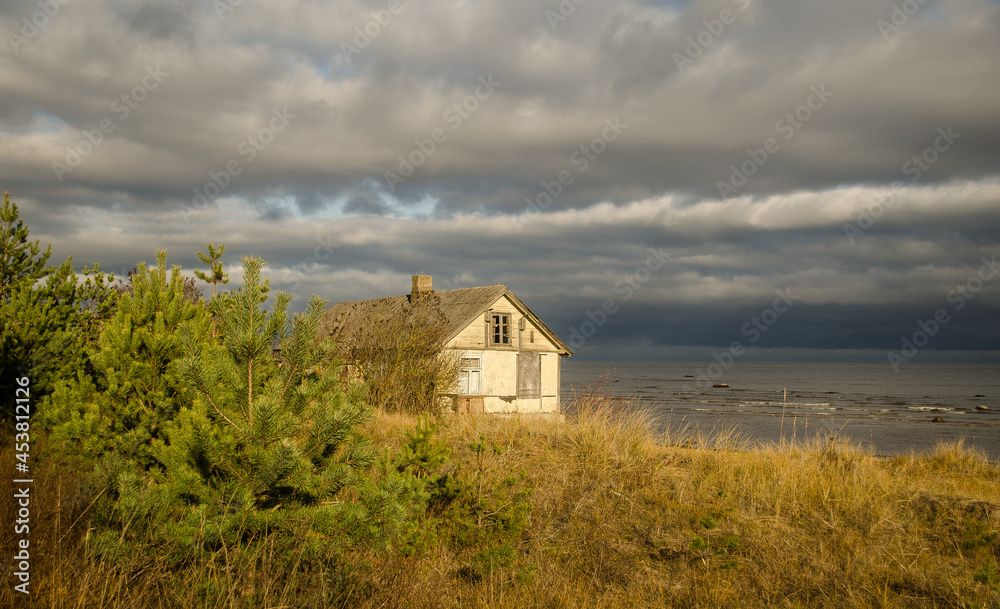 An old, abandoned wooden house by the sea. An old, abandoned wooden house by the sea.