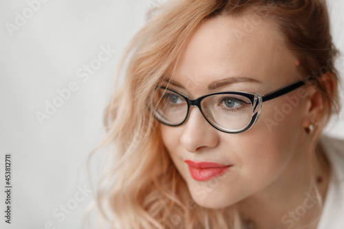 Beautiful woman in black eyeglasses with red lips. Close up portrait of beautiful young businesswoman wearing eyeglasses. Business woman in glasses .
