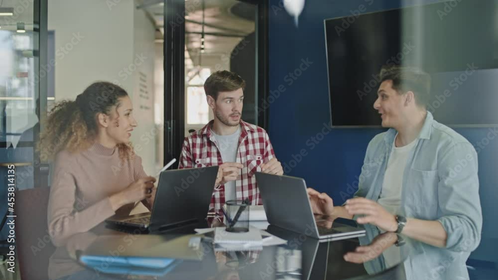 Game developers brainstorming in conference room, startup business ideas, team