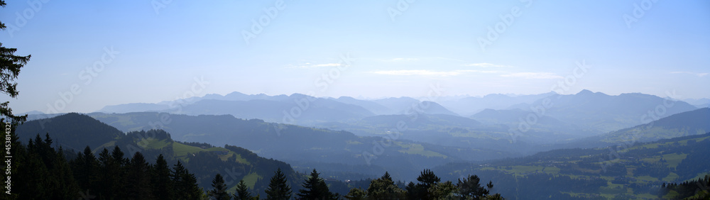 Beautiful wide angle scenic mountain panorama seen from local mountain Pfänder on a sunny summer day. Photo taken August 15th, 2021, Bregenz, Austria.