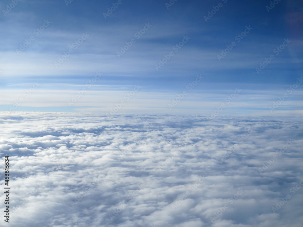 cloud landscape seen from airplane with blue sky