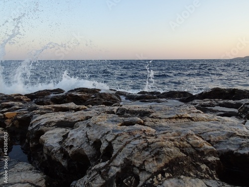 waves crashing on rocks during sunset in mediterranean August 29 2021 