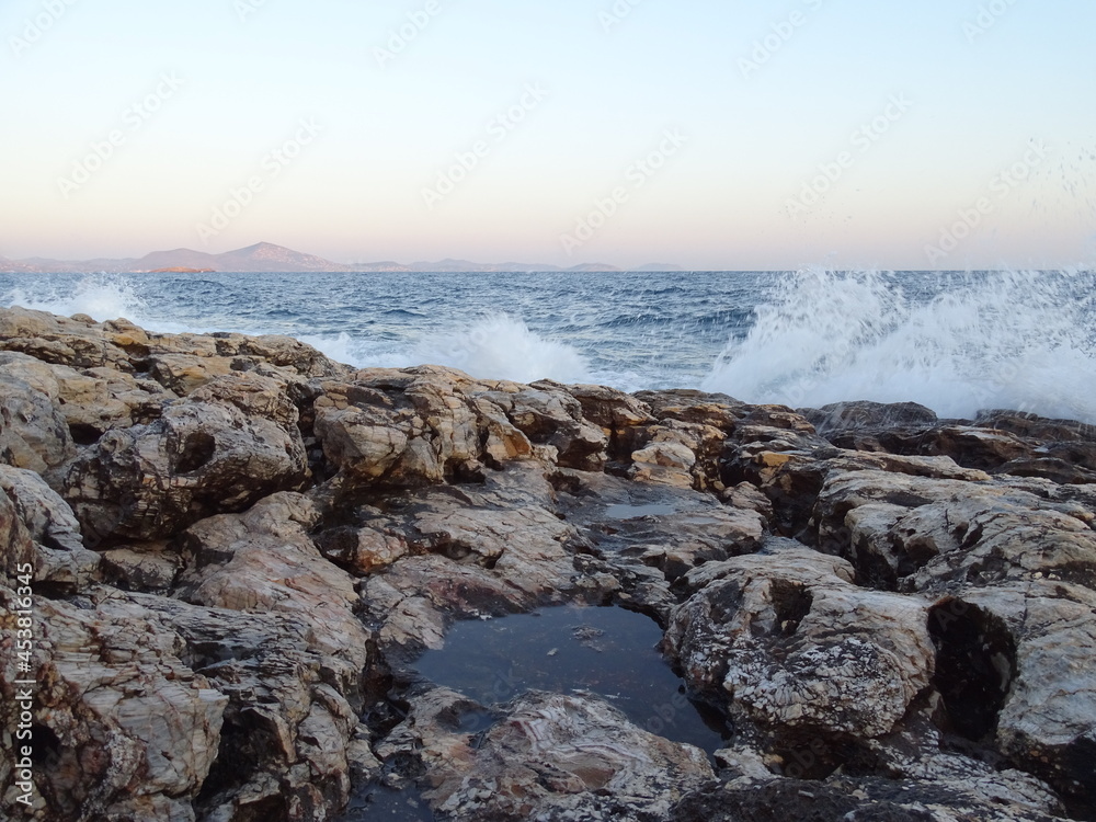 waves crashing on rocks during sunset  in mediterranean August 29  2021 
