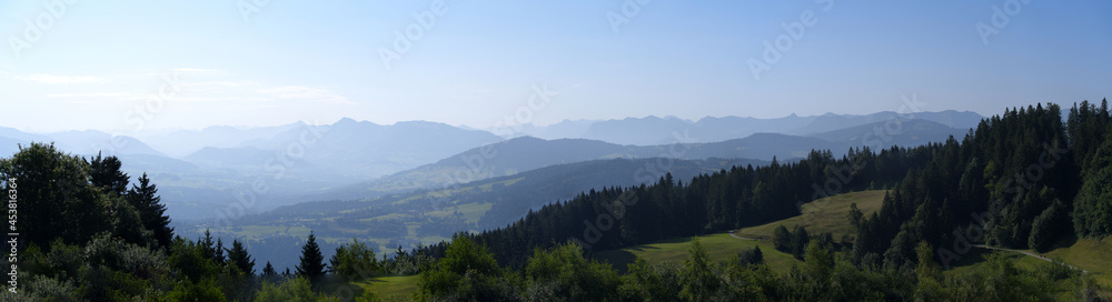 Beautiful wide angle scenic mountain panorama seen from local mountain Pfänder on a sunny summer day. Photo taken August 15th, 2021, Bregenz, Austria.