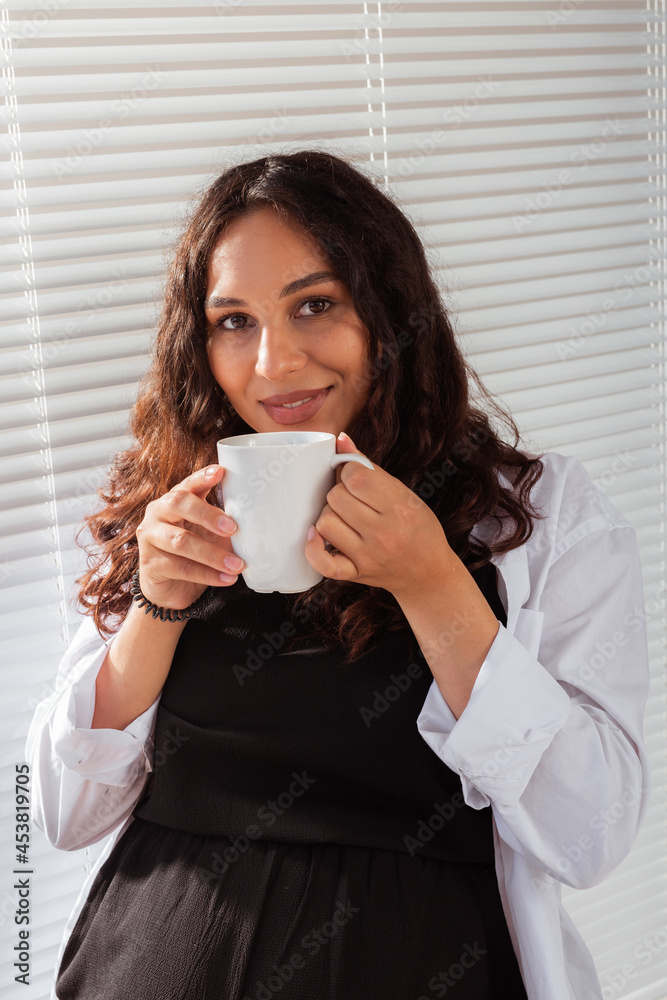 Happy pregnant young beautiful woman drinks tea during morning breakfast. Concept of pleasant morning and positive attitude during pregnancy Happy pregnant young beautiful woman drinks tea during morning breakfast. Concept of pleasant morning and positive attitude during pregnancy