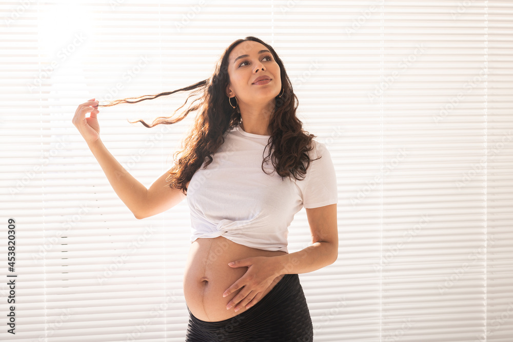 Pregnant woman touching her belly, copy space. Pregnancy and maternity leave Pregnant woman touching her belly, copy space. Pregnancy and maternity leave
