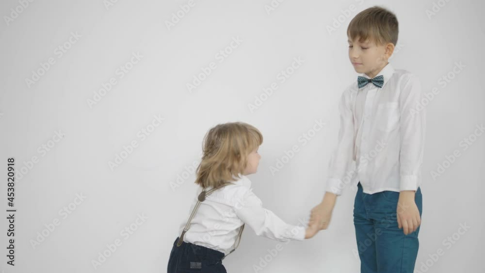 Two children shaking hands, family agreement Two children shaking hands, family agreement