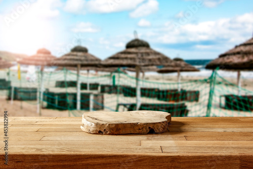 Fototapeta Naklejka Na Ścianę i Meble -  Wooden platform on the table for standing product against the background of the autumn sea landscape with the midday sun 
