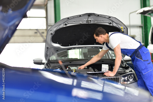 car mechanic works in a workshop, repair of cars