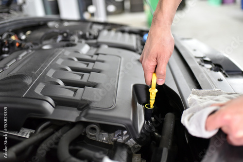 oil level control of the car engine by mechanics in a car workshop © industrieblick