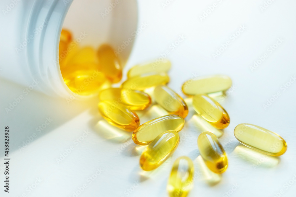 Capsules omega 3 fatty acids scattered from the packaging fish oil closeup Capsules omega 3 fatty acids scattered from the packaging fish oil closeup