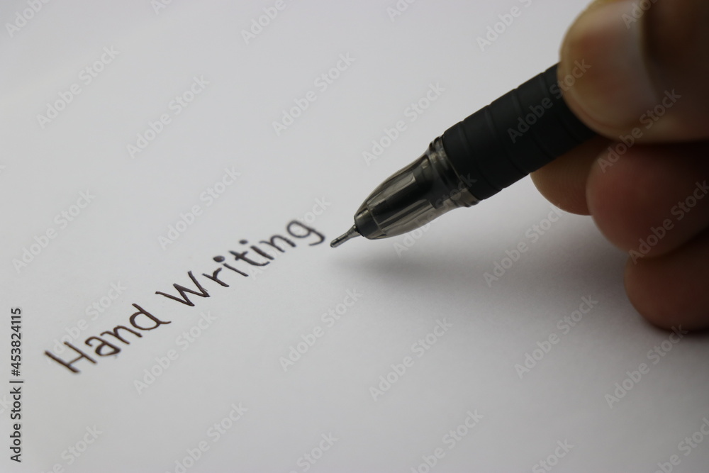 Hand writing being written on plane sheet of paper by black pen, Concept showing fonts of handwriting Hand writing being written on plane sheet of paper by black pen, Concept showing fonts of handwriting